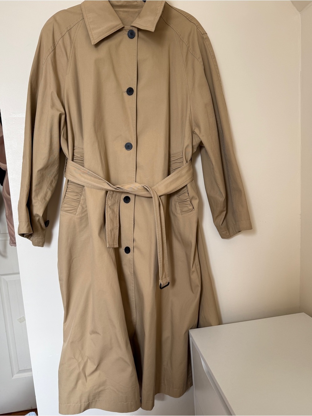 Classic women’s long trench-style coat in a timeless beige / camel shade.